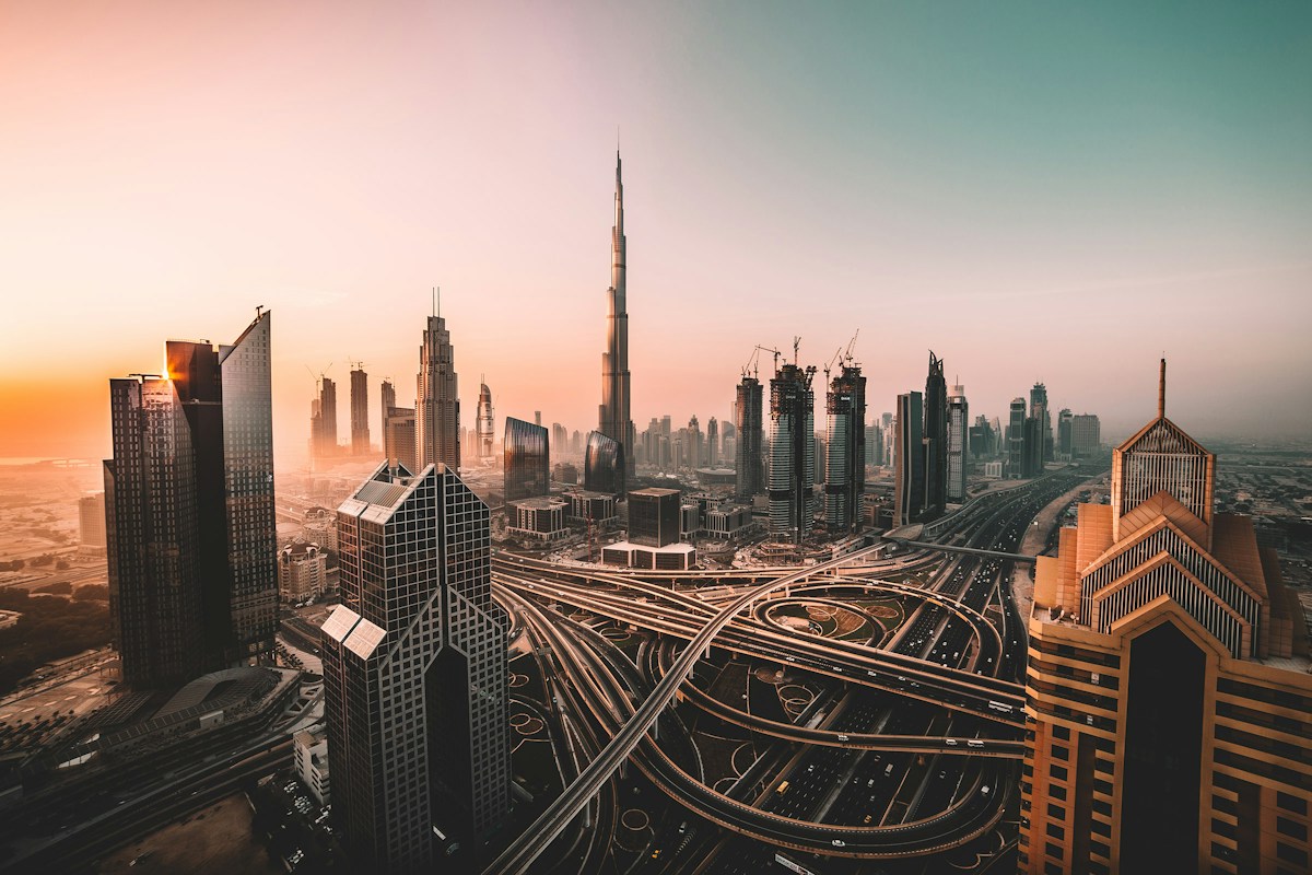 Dubai skyline with high-rise developments, construction cranes, and major urban road networks